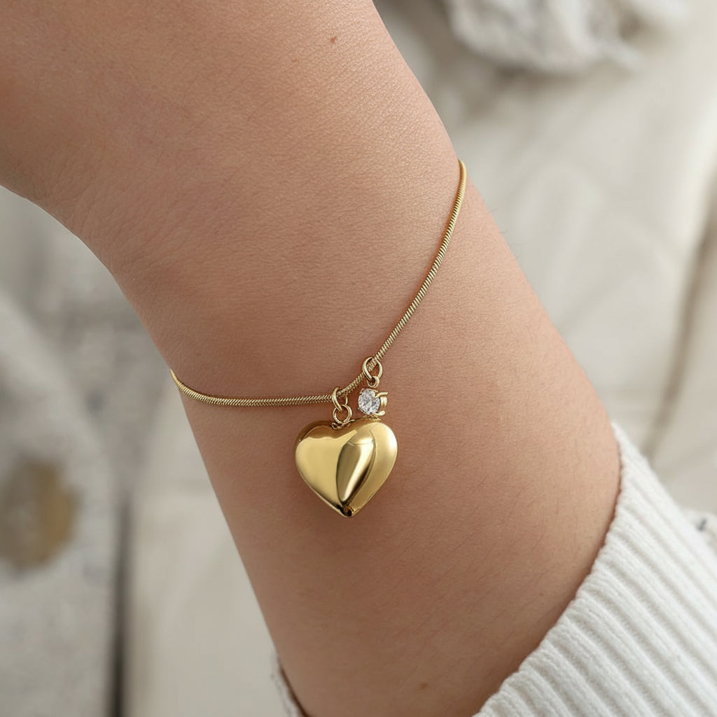 Gold puffed heart charm bracelet with crystal accent on delicate snake chain