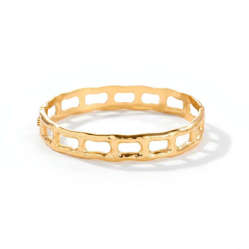 Gold-plated geometric bangle with architectural cutout frame design - narukvica