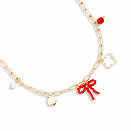 Gold-plated stainless steel paperclip chain necklace with curated charms including red beaded bow, quatrefoil, freshwater pearl, polished disc, and red crystal – ogrlica