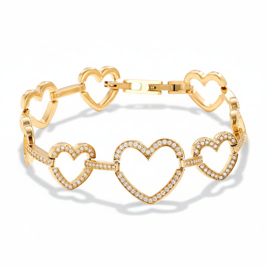 Gold linked hearts bracelet worn on wrist showing cubic zirconia-lined heart connections