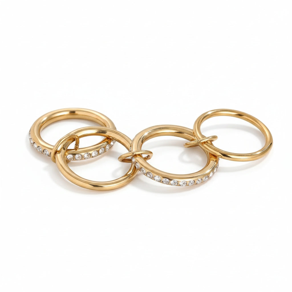 Gold hoop earrings with embedded stones on a gray background