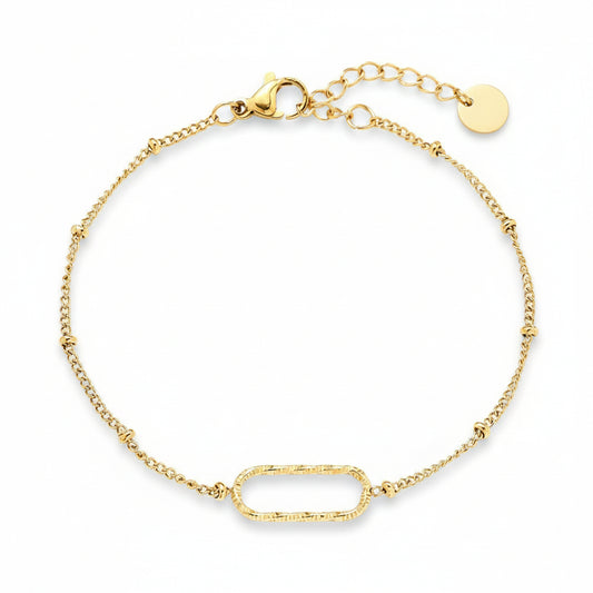 Gold oval link bracelet with textured centerpiece on delicate satellite chain