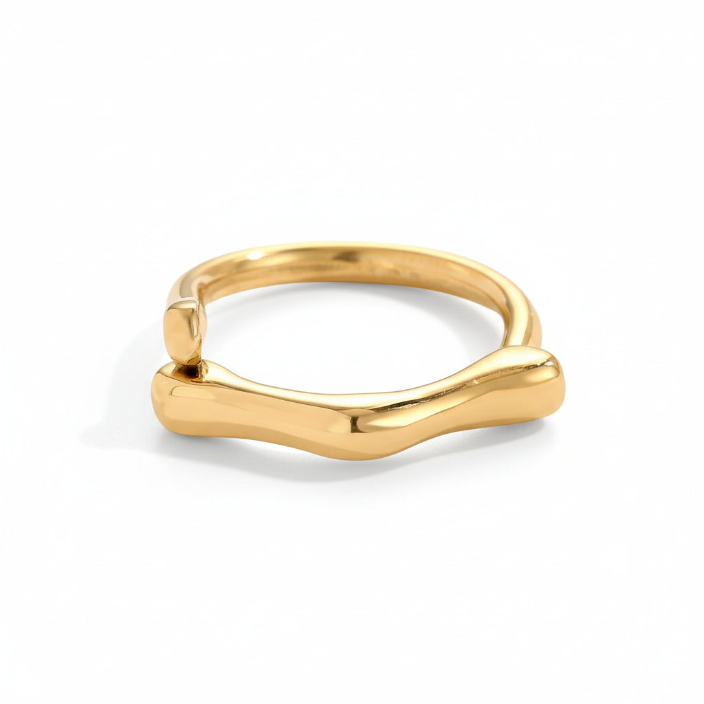 Gold ring with a modern design on a light gray background
