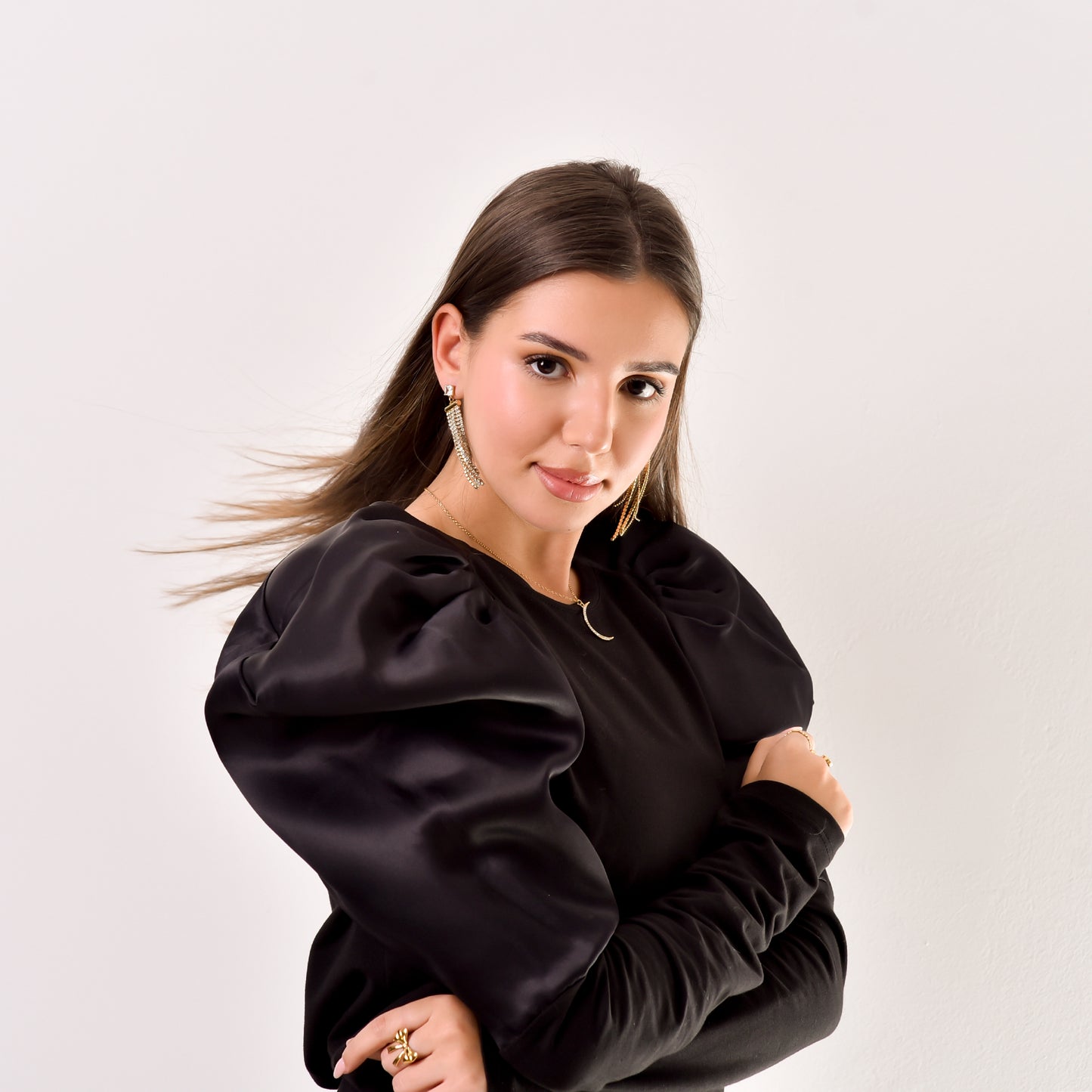 Woman wearing a black outfit against a white background