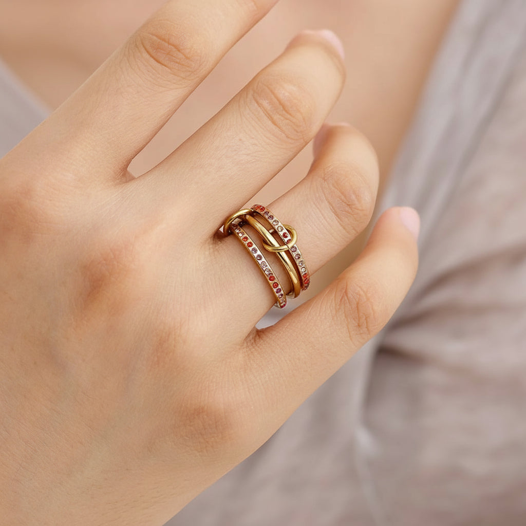 gold triple-band linked ring with pink and orange gradient zircon stones