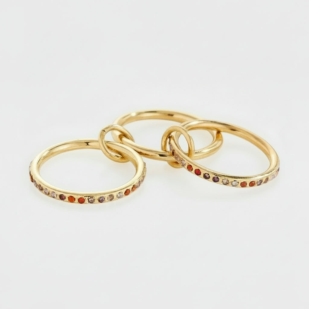 gold triple-band linked ring with pink and orange gradient zircon stones