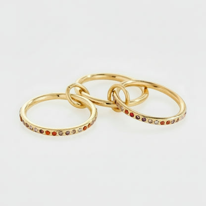 gold triple-band linked ring with pink and orange gradient zircon stones