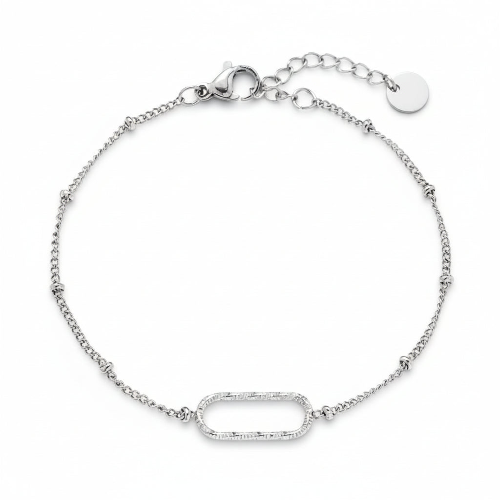 Silver oval link bracelet with textured centerpiece on delicate satellite chain