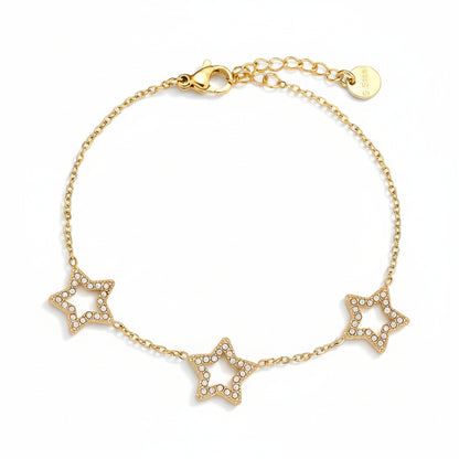 Gold bracelet with three star charms on white background – narukvica