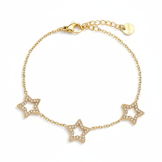 Gold bracelet with three star charms on white background – narukvica