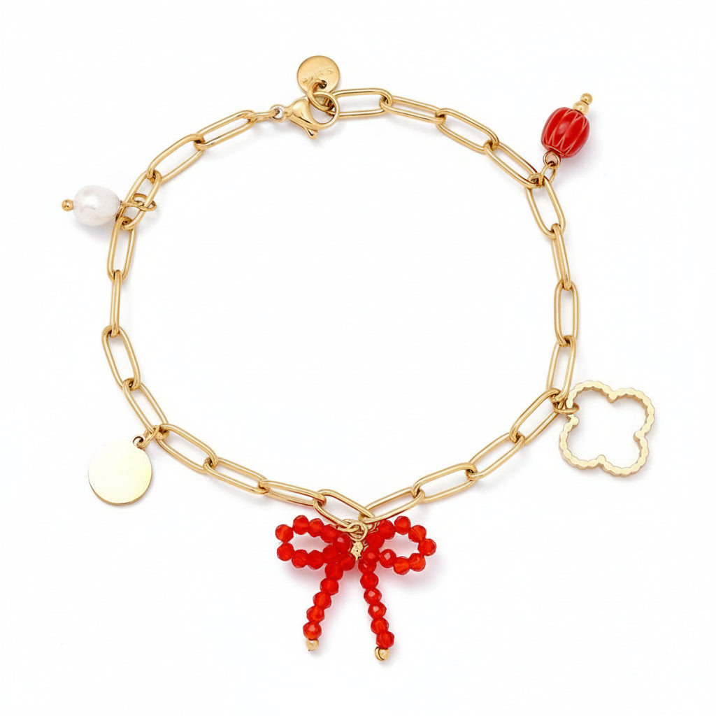  Gold paperclip chain bracelet with mixed charms including crystal beaded bow, freshwater pearl, clover, and disc