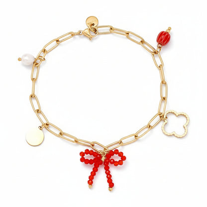  Gold paperclip chain bracelet with mixed charms including crystal beaded bow, freshwater pearl, clover, and disc