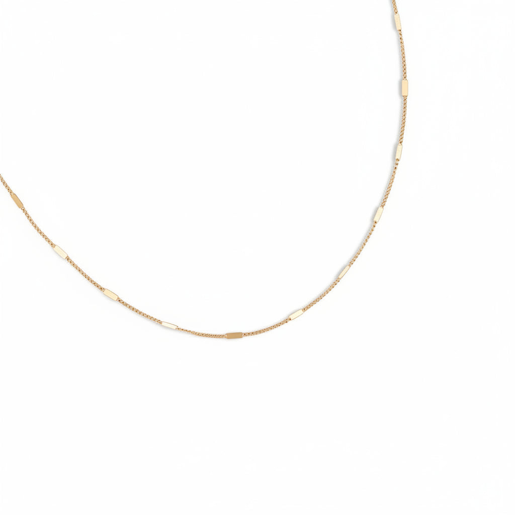 Gold chain necklace on a white background